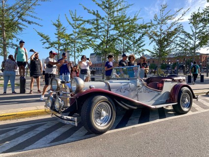 Tourists admire a 1929 Mercedes-Benz Gazelle SSK Replica in Puerto Madero, Buenos Aires, Argentina