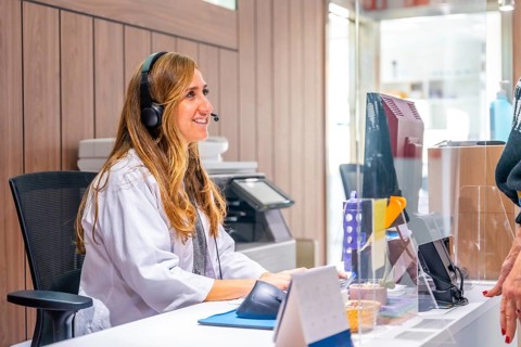 Woman in lab coat working in the reception of an hospital