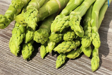 Green asparagus decorated on a rustic wooden table