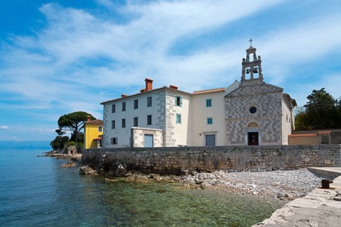 Coastal view with a building and a church by the clear blue sea, St Mary's Monastery, Glavotok,