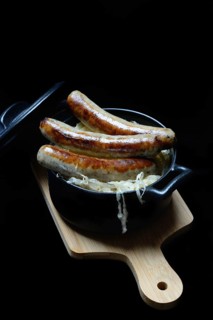 Nuremberg sausages with sauerkraut in a pot, Rostbratwurst, Germany