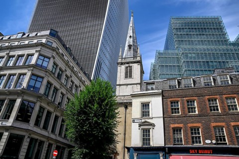 St Clement Eastcheap church tower in front of the skyscrapers of the Broadgate district, banking