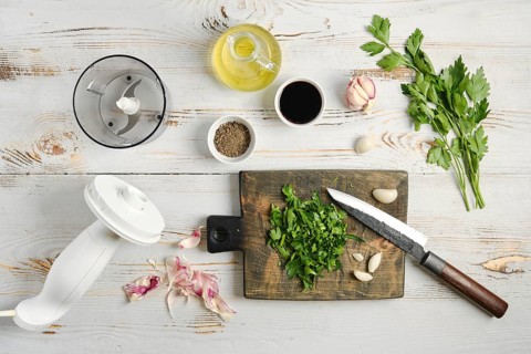 Chopped fresh parsley and garlic ready to be mixed in food processor with olive oil, soy sauce and