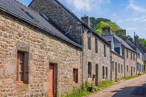 Old historic residential buildings on a street in the french village of Locronan, Locronan,