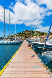 Jetty with anchored sailing yachts, harbour of Port Azzurro, Elba Island, Tuscan Archipelago