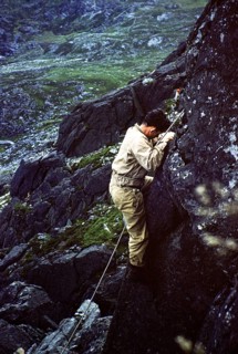 Young male climber on a rock face with climbing rope, probably North Wales, Great Britain around