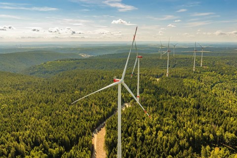 Large wind turbines on a wooded hill that stretches to the horizon, Besenfeld, Freudenstadt
