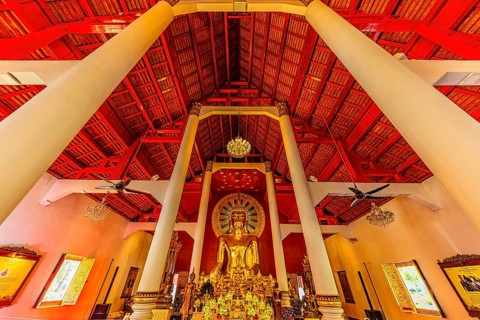 Gilded Buddha statue in a public prayer hall in the Wat Phra Singh Buddhist temple complex, Chiang