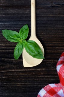 Cooking spoon and basil (Ocimum basilicum)