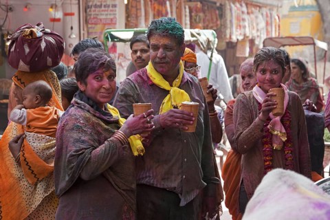 Pelgrims dyed in red celebrating the Holi festival in Vrindavan, Uttar Pradesh, India