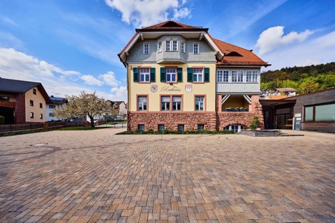 Town hall, commercial building, façade with windows, shutters and façade painting, hipped roof,