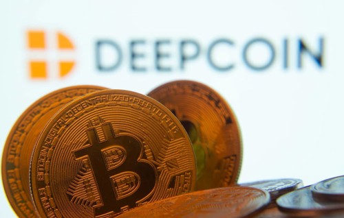 Dhaka, Bangladesh- 03 Oct 2025: Close-up of Bitcoin coins with the Deepcoin logo visible on a