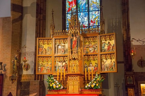 Elaborately designed altar with religious works of art and stained glass windows, St. Jakobi
