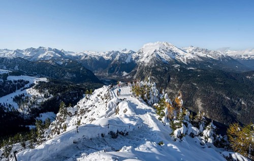 Hiking trail on the snow-covered summit of the Jenner with viewing platform in autumn, view of