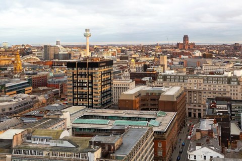 View over city centre rooftops to the Anglican cathedral, Liverpool, England, UK