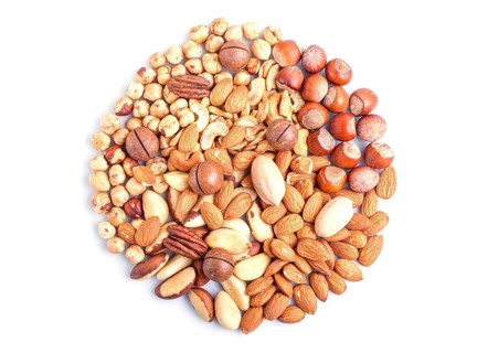 Circle made from different kinds of nuts isolated on white background. hazelnut, brazil nut,