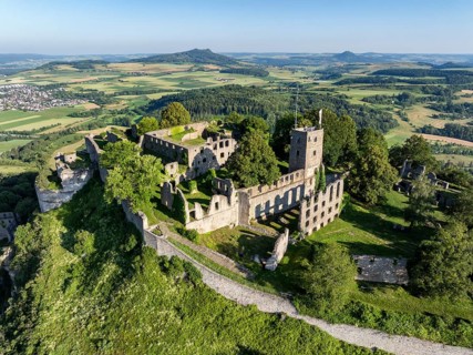 Aerial view of the volcanic cone Hohentwiel with Germany's largest fortress ruins, on the horizon