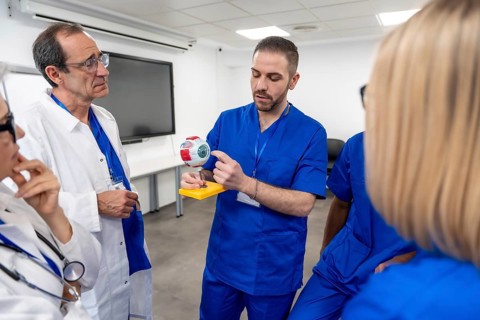 Healthcare instructor explaining human eye anatomy to a class of medical students or colleagues,