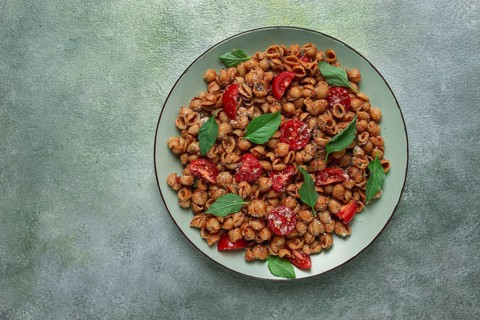 Tuscan pasta with smoked paprika and basil, parmesan cheese, Italian traditional cuisine