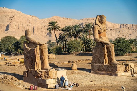 Statues in the ruins of the temple of Amenhotep III in the Nile Valley in West Thebes near Luxor,