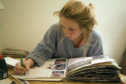 Model released image of teenage girl working on her art folder