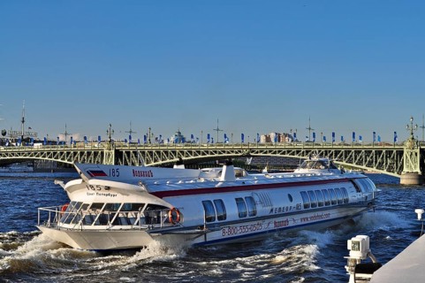 A speedboat, hydrofoil Meteor, travels near a bridge on a river in the city, Saint Petersburg, St.