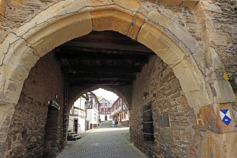View through historic town gate, clock tower, landmark on clock tower alley, monument protection,