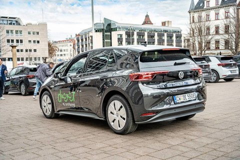 Rear view of a black Volkswagen electric car in a municipal parking lot, Deer, e-carsharing,