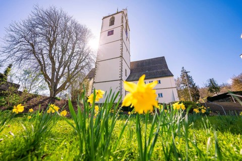 Easter bells in a meadow in front of a church in bright sunshine, Aidlingen, Böblingen district,