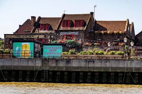 The historic Anchor pub with its riverside terrace on Bankside, overlooking the River Thames in