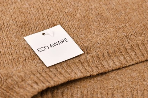 Eco aware label attached to environmental friendly produced pullover