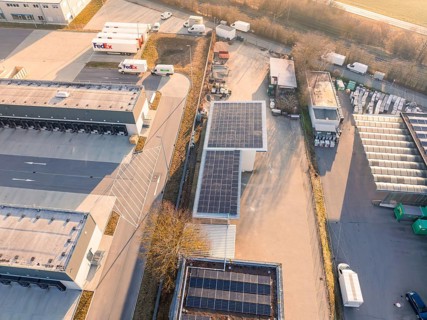 Industrial area with solar panels, trucks and storage areas in a rural area, Bauhof, Nufringen,
