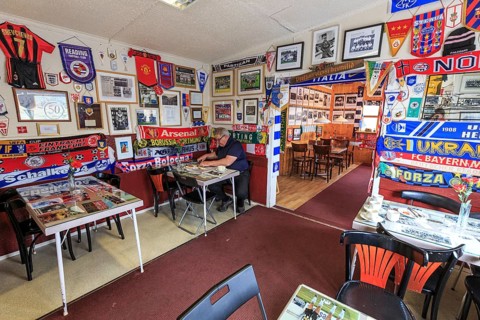 Interior shot of a petrol station, café, football fan, football club accessories and souvenirs,
