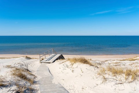 A wooden walking path leading to the stairs to the beach on the Curonian Spit on the Baltic Sea,