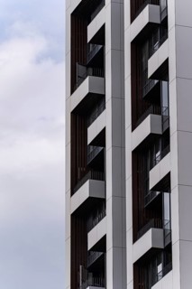 Close-up of a contemporary high-rise building showcasing sleek design elements and geometric