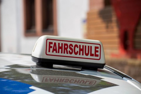 Close-up of a driving school sign in Germany