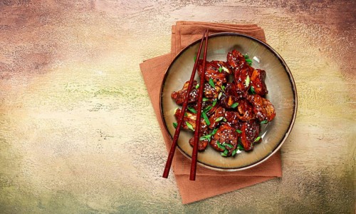Yakitori chicken kebab, on a plate, with green onions and sesame seeds, top view, no people