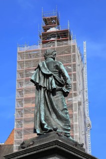 Picture shows the bronze statue of Polish poet Adam Mickiewicz on the main square with a view of St