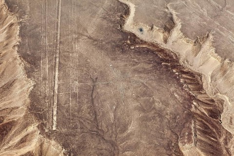 Lines visible from the air and a cross pattern on a dry, hilly sandy area, the geoglyphs and images