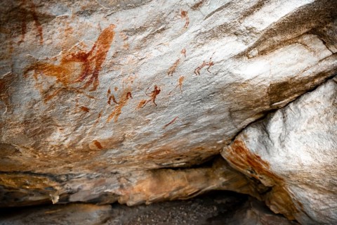 Prehistoric animal depictions and hunters, ancient rock carving of the San, natives of South