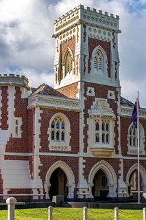 Auckland High Court heritage building with Gothic Revival castellated tower, red brick and white