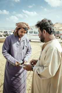 Camel dealer with customer, camel souk Salalah, Dhofar, Oman