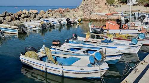 Fishing boats with nets in a small harbour with rocky surroundings, Stegna Beach, Stegna viewpoint,