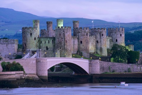 Conwy Castle at dusk beside the Conwy estuary, North Wales, United Kingdom