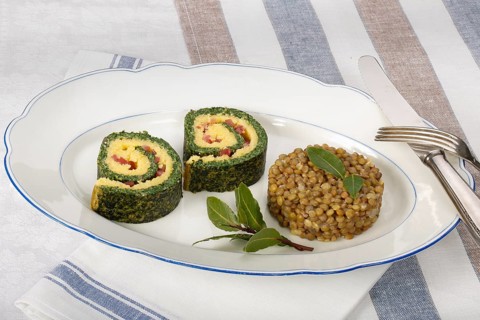 Southern German cuisine, polenta spinach roulade with alblentils served on serving platter, bay