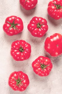 Pink tomatoes scattered on the table, top view, close-up, no people