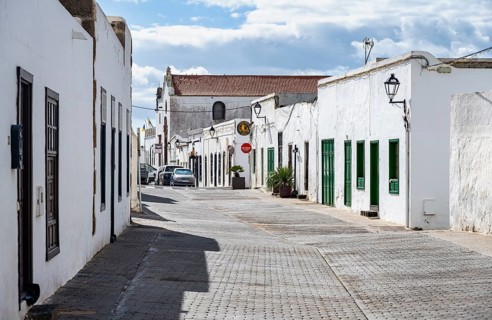 Typical white houses with colored doors and windows in an alley, Teguise, Lanzarote, Canary