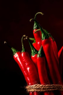 Bunch of red hot chili pepper, close-up, on a dark background, selective focus, no people, concept,