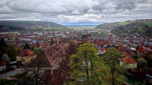 View from the fortress over Kronach with surrounding green hills in spring and cloudy sky, Veste