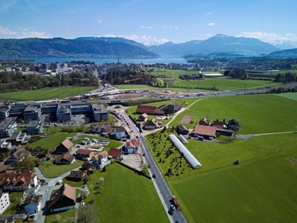 View of Lindencham with the motorway entrance, Lake Zug and Mount Rigi in the back, Cham, Canton of